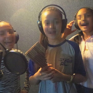 Keren Hayeled girl singing in the recording studio during an extracurricular choir program at the orphanage