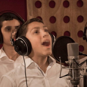 Keren Hayeled boy singing in the recording studio for the extracurricular choir program at the orphanage