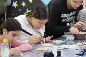 Keren Hayeled girls focusing on their arts and crafts project