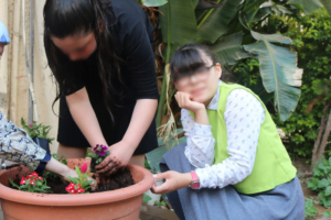 Keren Hayeled orphanage girls enjoying gardening and planting flowers
