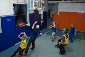 Keren Hayeled boys playing basketball in the orphanage gym